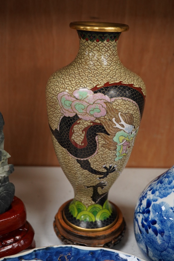 A Japanese Imari dish an Arita bottle vase together with a Chinese cloisonné enamel vase and a Chinese hardstone boulder carving, largest 34cm in diameter